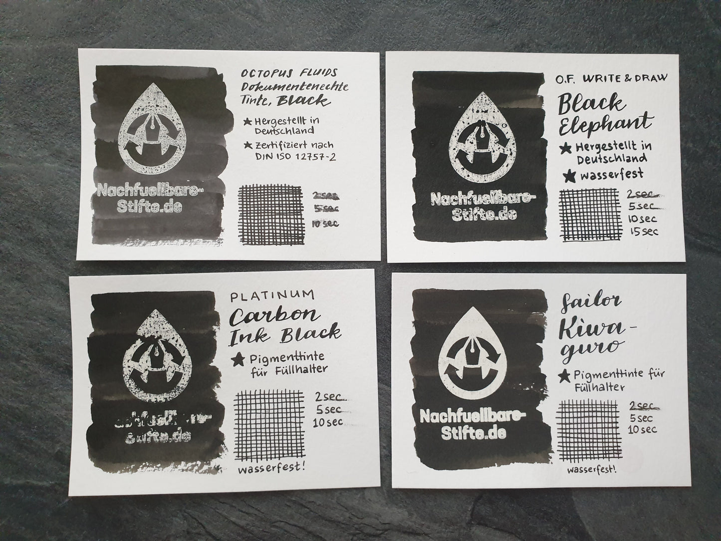 Vergleichsfoto mit Tintenswatches von wasserfesten schwarzen Füllertinten: Octopus Fluids Dokumentenechte Tinte Black, Octopus Fluids Write & Draw Black Elephant, Platinum Carbon Ink Black, Sailor Kiwaguro